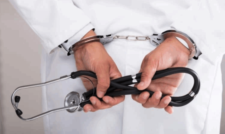 Doctor in a white coat with hands cuffed behind their back holding a stethoscope, representing medical malpractice accountability in Connecticut