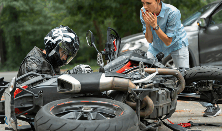 Motorcycle crash scene with injured rider wearing a helmet and a concerned woman approaching, highlighting serious motorcycle accidents in Connecticut