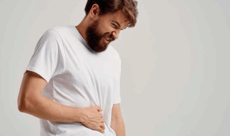 Man in visible pain holding his side, symbolizing abdominal injury cases handled by L.A. LAW for accident victims in Connecticut.