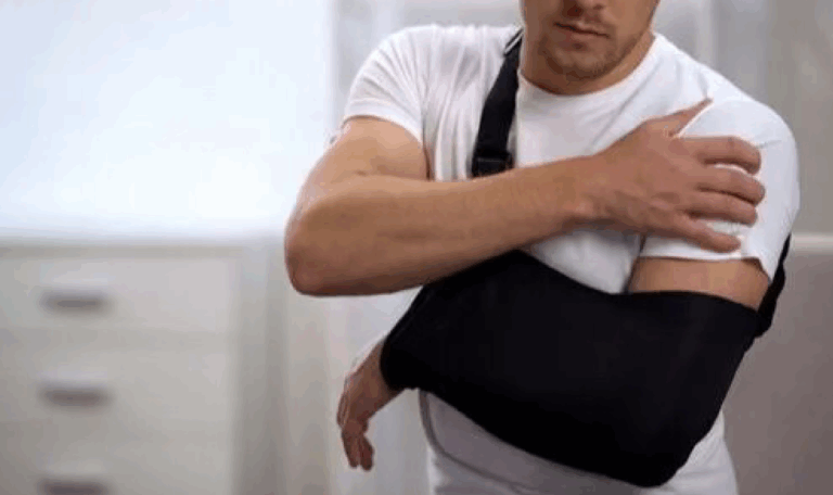 Man gripping his shoulder in pain, symbolizing shoulder injury cases handled by L.A. LAW for accident victims in Connecticut.